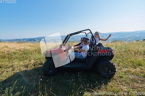 Image of group young happy people enjoying beautiful sunny day while driving a off road buggy car