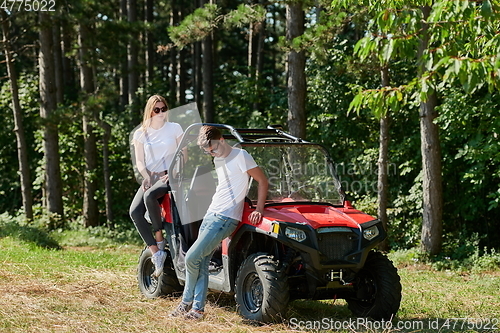 Image of couple enjoying beautiful sunny day while driving a off road buggy