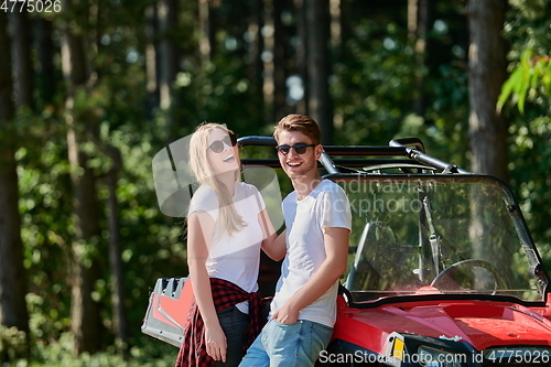 Image of couple enjoying beautiful sunny day while driving a off road buggy