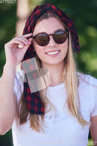 Image of portrait of beautiful, emotional, young woman in sunglasses.