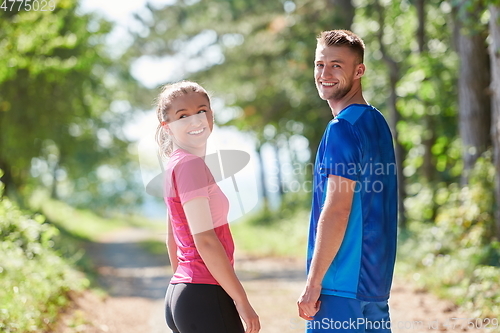 Image of couple enjoying in a healthy lifestyle while jogging on a country road