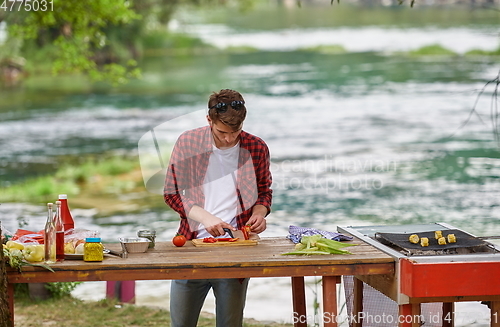 Image of man cooking tasty food for french dinner party