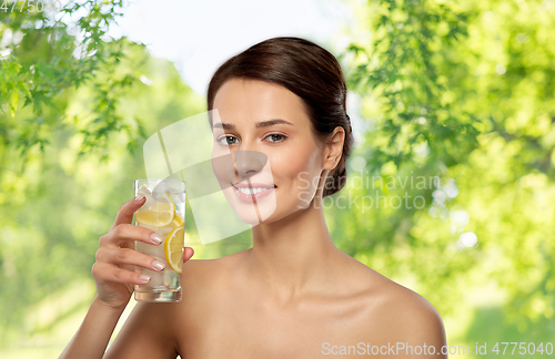 Image of woman drinking water with lemon and ice