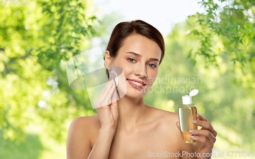 Image of young woman with toner or cleanser and cotton pad