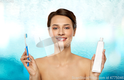 Image of smiling woman with toothbrush cleaning teeth