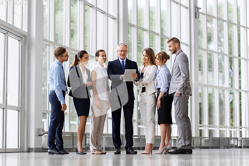 Image of business people with tablet pc computer at office