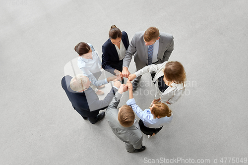 Image of happy business people making fist bump