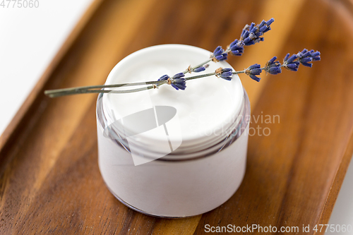 Image of close up of lavender moisturizer on wooden tray