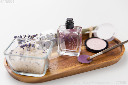 Image of sea salt, perfume and lavender on wooden tray