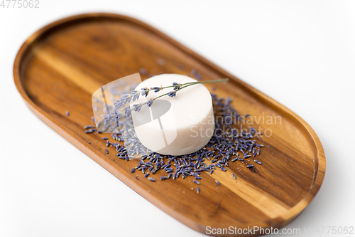 Image of close up of crafted lavender soap on wooden tray