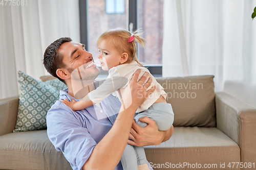 Image of father with little baby daughter at home