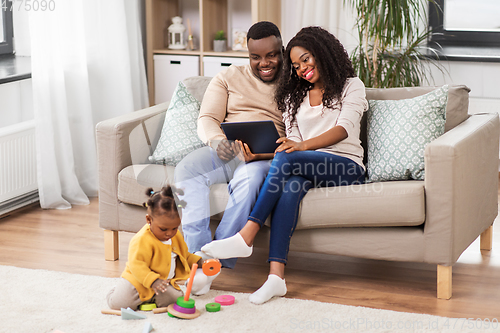 Image of family with tablet pc and toy blocks at home