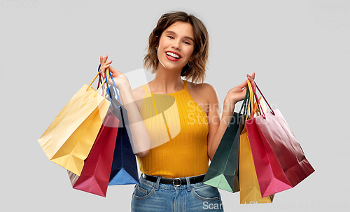 Image of happy smiling young woman with shopping bags