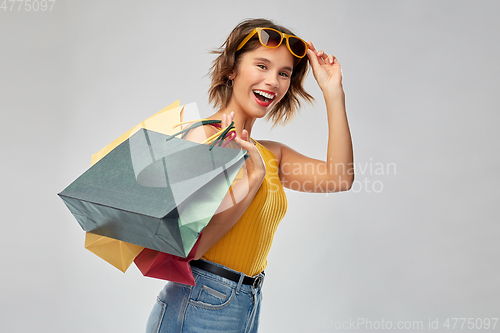 Image of happy smiling young woman with shopping bags