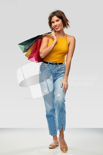 Image of happy smiling young woman with shopping bags