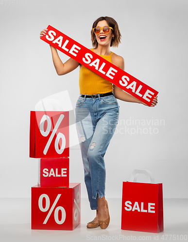 Image of happy smiling young woman with shopping bags