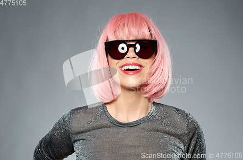 Image of happy woman in pink wig and black sunglasses