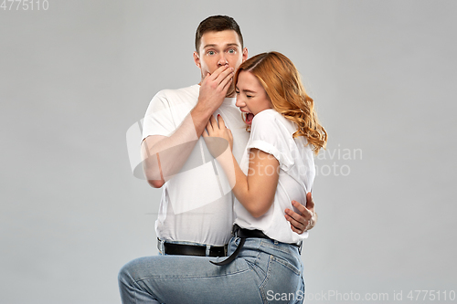 Image of scared couple in white t-shirts