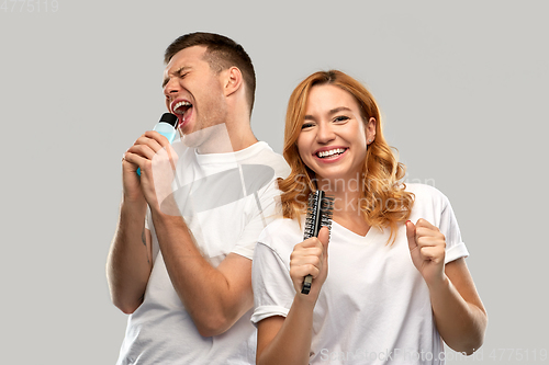 Image of happy couple singing to hairbrush and lotion