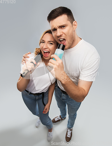 Image of happy couple singing to hairbrush and lotion