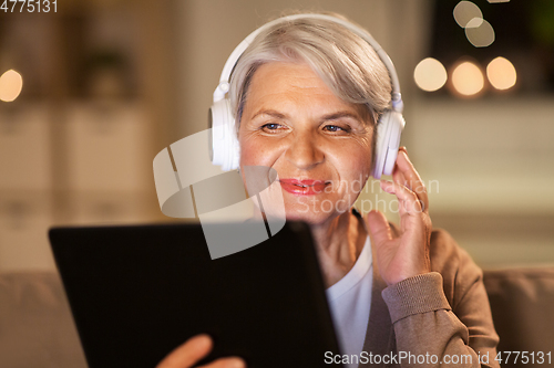Image of senior woman in headphones listening to music