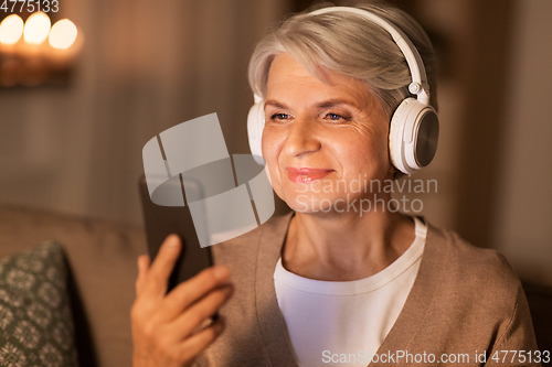 Image of senior woman in headphones listening to music