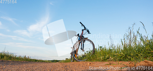 Image of Single bike next to dirt road