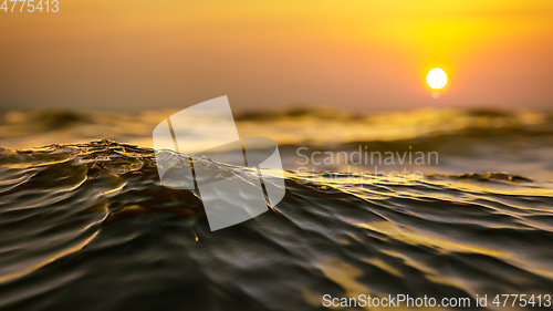 Image of golden sunset ocean wave background