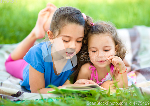 Image of Two little girls are reading book