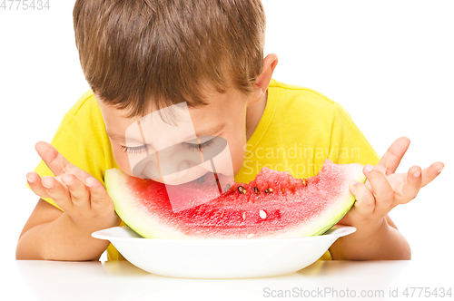 Image of Little boy is eating watermelon