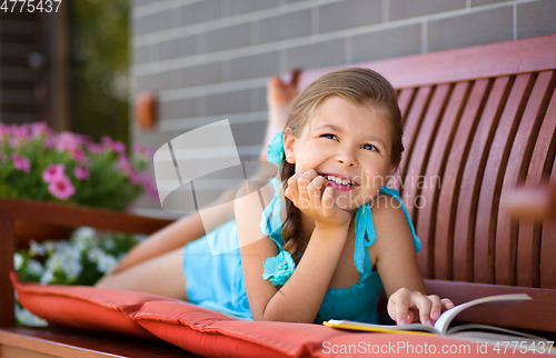 Image of Little girl is reading a book