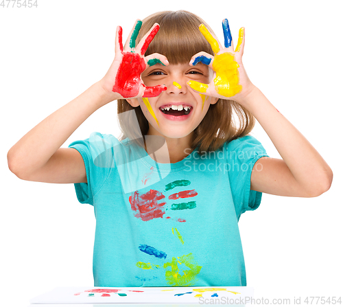 Image of Portrait of a cute girl playing with paints