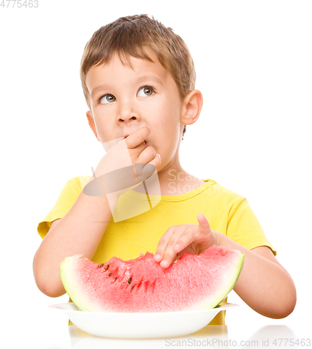 Image of Little boy is eating watermelon