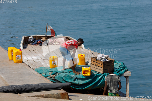 Image of Malagasy men transport cargo from ship in port of Nosy Be, Madag