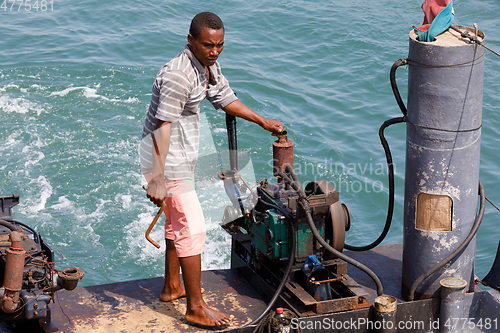 Image of man manages the ship in port of Nosy Be, Madagascar