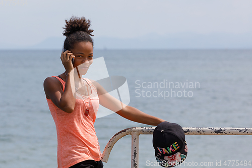 Image of Malagasy woman take phone calling Nosy Be port, Madagascar