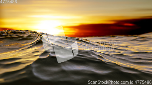 Image of golden sunset ocean wave background