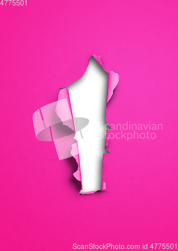Image of Pink torn paper with hole