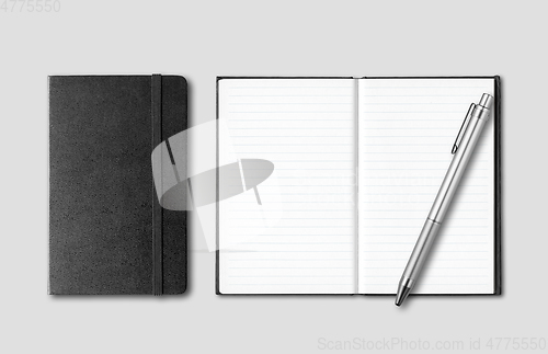 Image of Black closed and open notebooks with pen isolated on grey