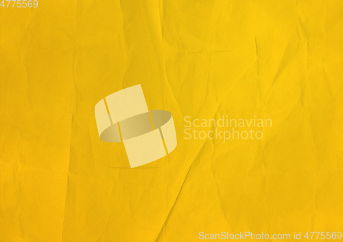 Image of yellow crumpled paper texture background