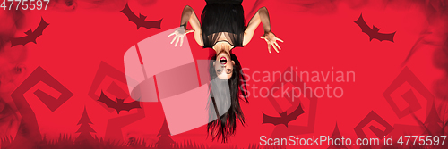 Image of Young woman in hat as a witch on scary red background