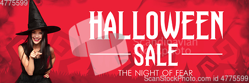 Image of Young woman in hat as a witch on scary red background