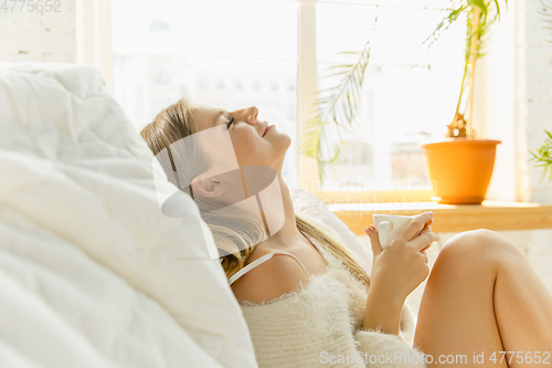 Image of Beautiful young woman relaxing at home, comfort and calm