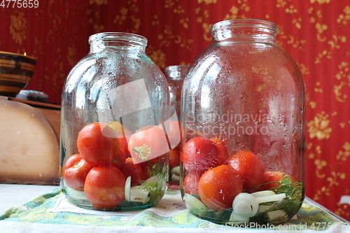 Image of tomatoes in jars prepared for preservation