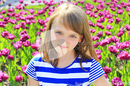Image of portrait beautiful young girl on lilac tulips background