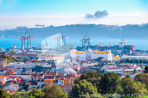Image of Lisbon skyline, cranes and cargo containers
