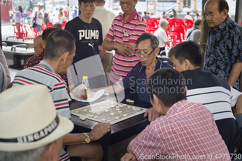 Image of Men play checkers Chinatown Singapore