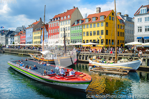 Image of Touristic boat cruising by Nyhavn 