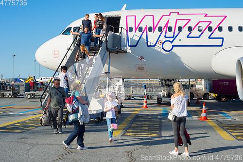 Image of Passengers people leave airplane airport