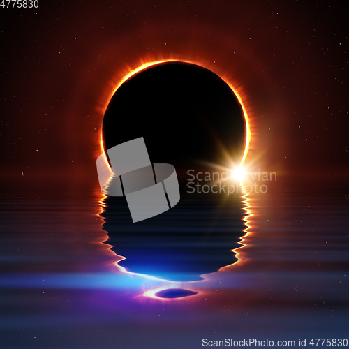 Image of total sun eclipse water reflection with stars and flare